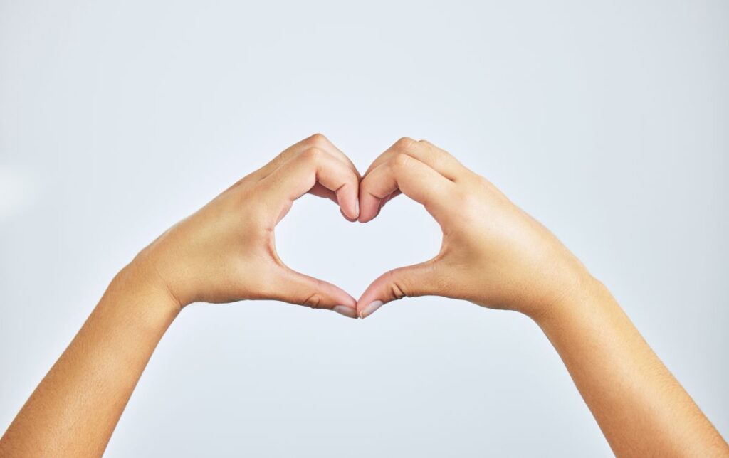 Hands,,Closeup,And,Person,In,Studio,With,Heart,Sign,,Gesture