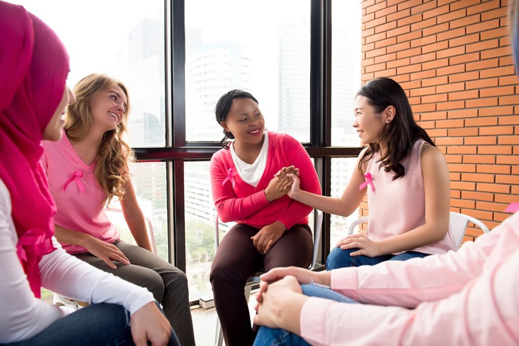 Multiethinic,Women,Wearing,Pink,Color,Clothes,Sitting,In,Circle,Talking