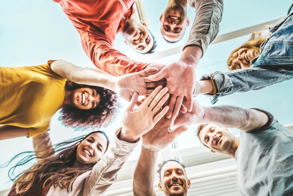 Group,Of,Young,People,Stacking,Hands,Together,Outdoor, ,Community