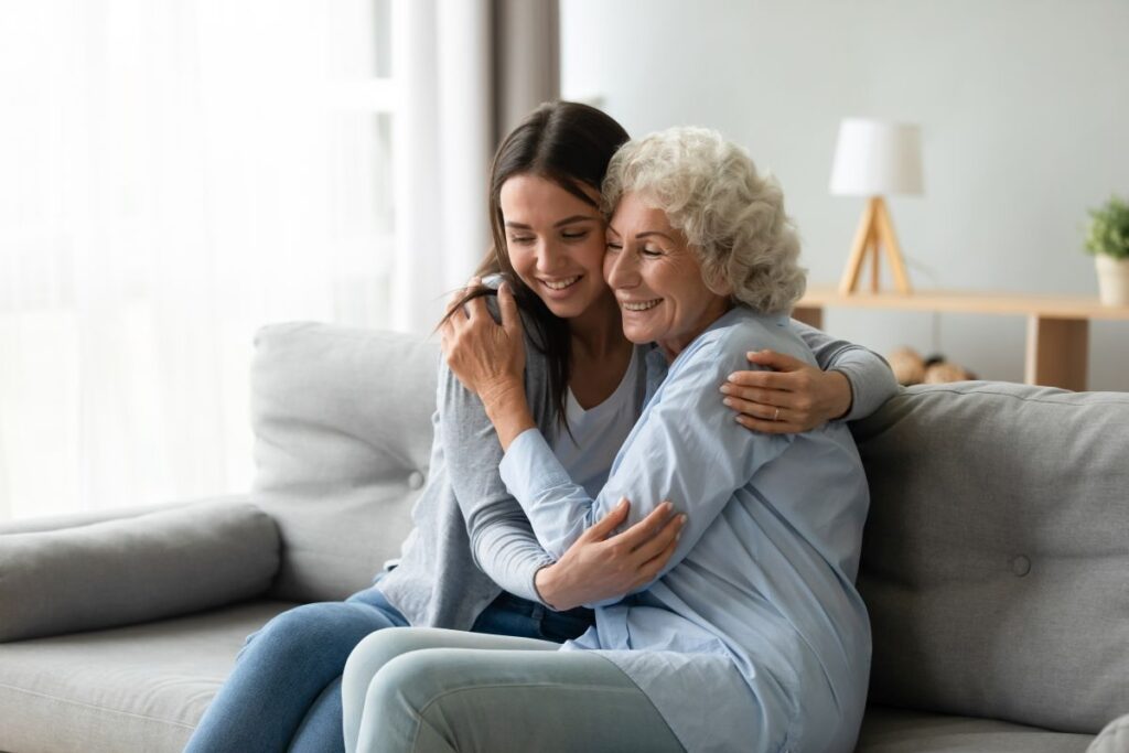 Happy,Multi generational,Family,Sitting,On,Couch,In,Living,Room,,Elderly