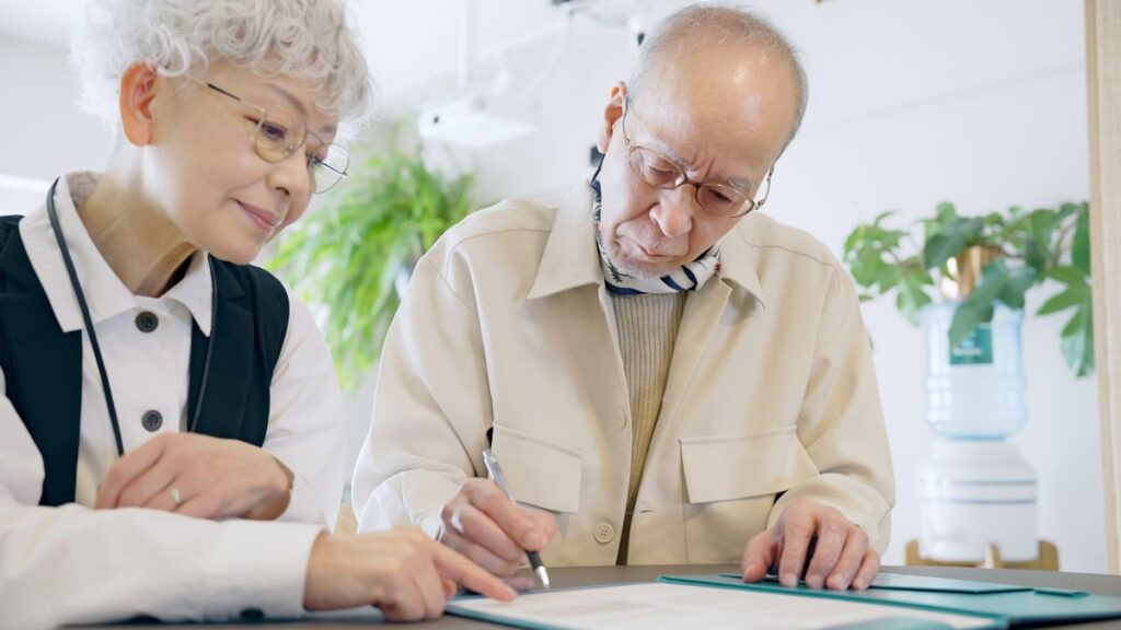 Asian,Elderly,Couple,Filling,Out,Paperwork.