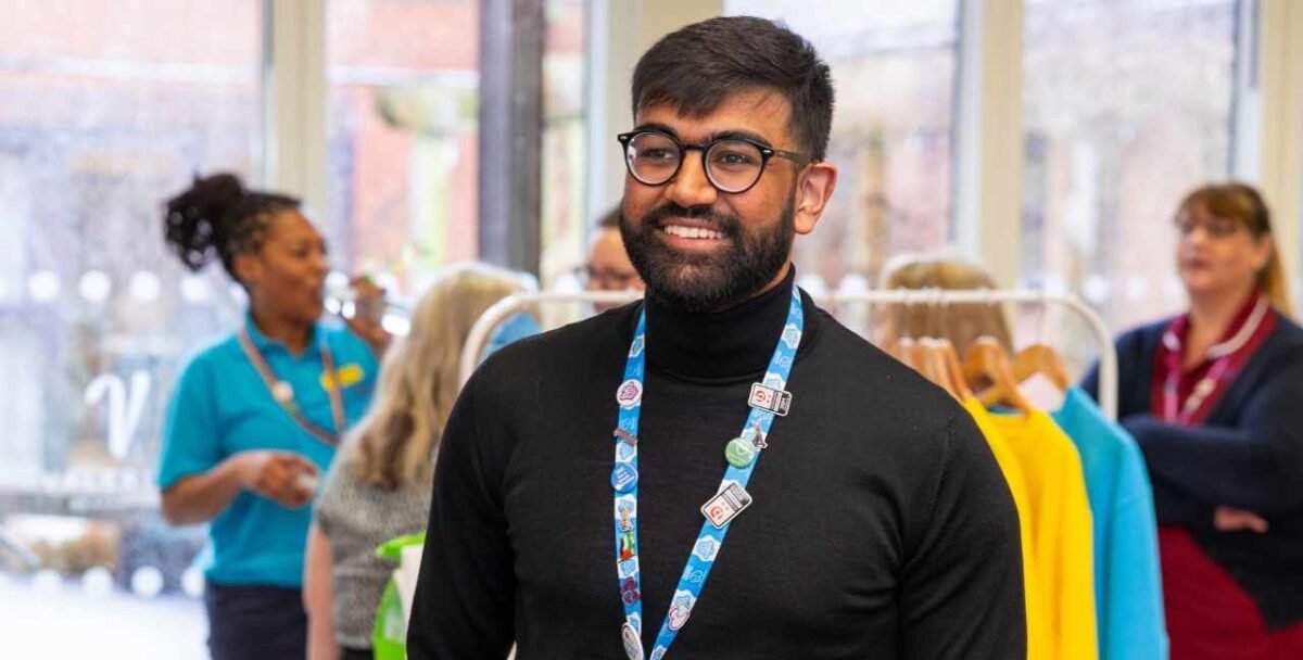 Professional male staff member smiling with glasses