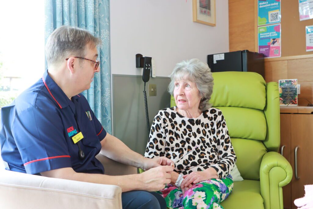 Nurse with adult patient on in patient unit