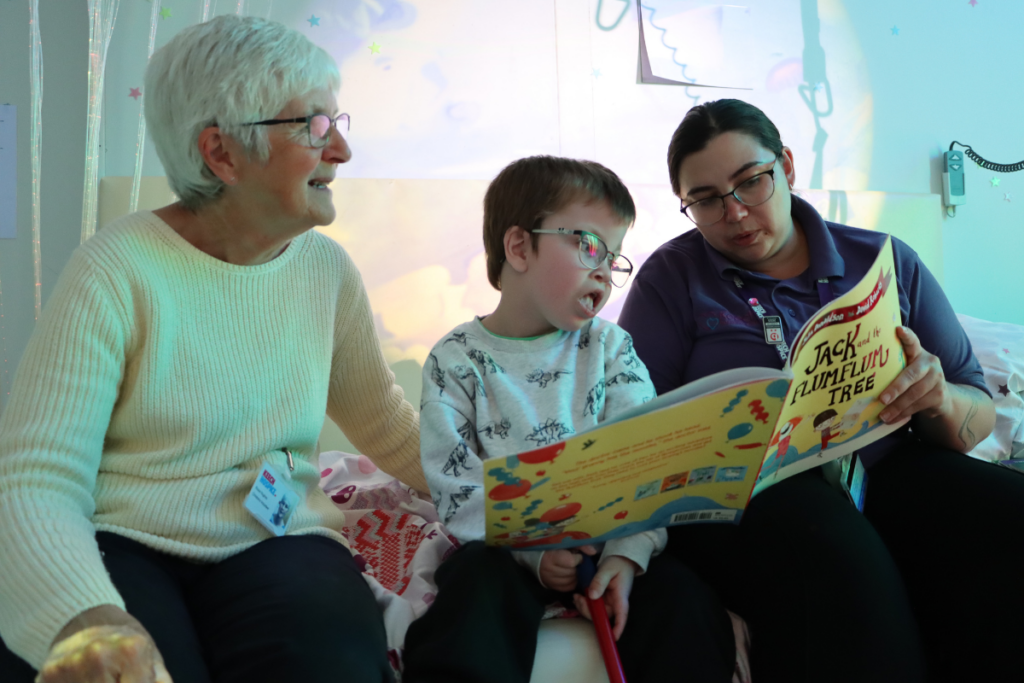 Rosie, a volunteer sat down with a child patient reading